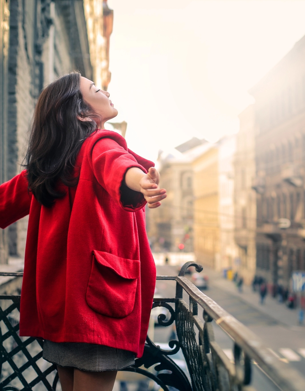 feelforeveryoung.com woman embracing the moment in red coat and skirt